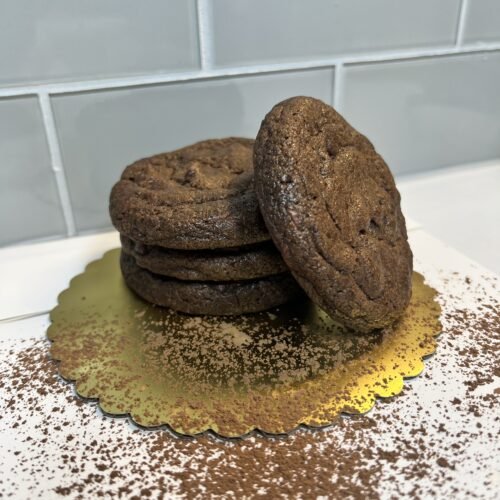 A Stack Of Double Chocolate Chip Cookie With A Dust Of Cocoa Powder