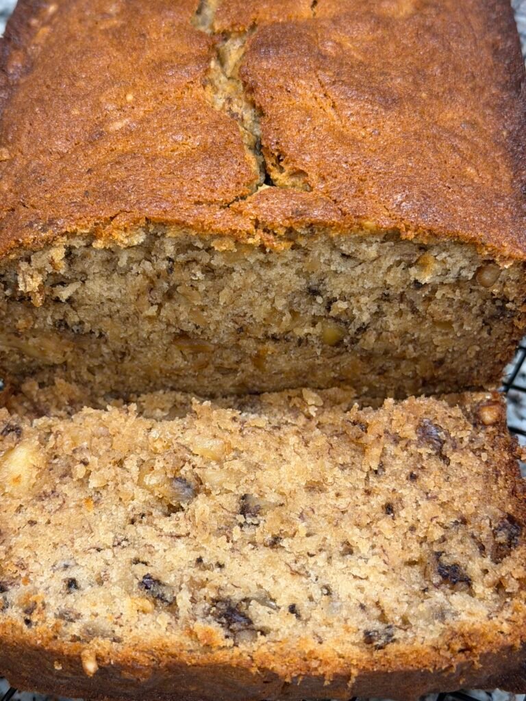 Award winning banana loft cake on a counter with piece sliced off