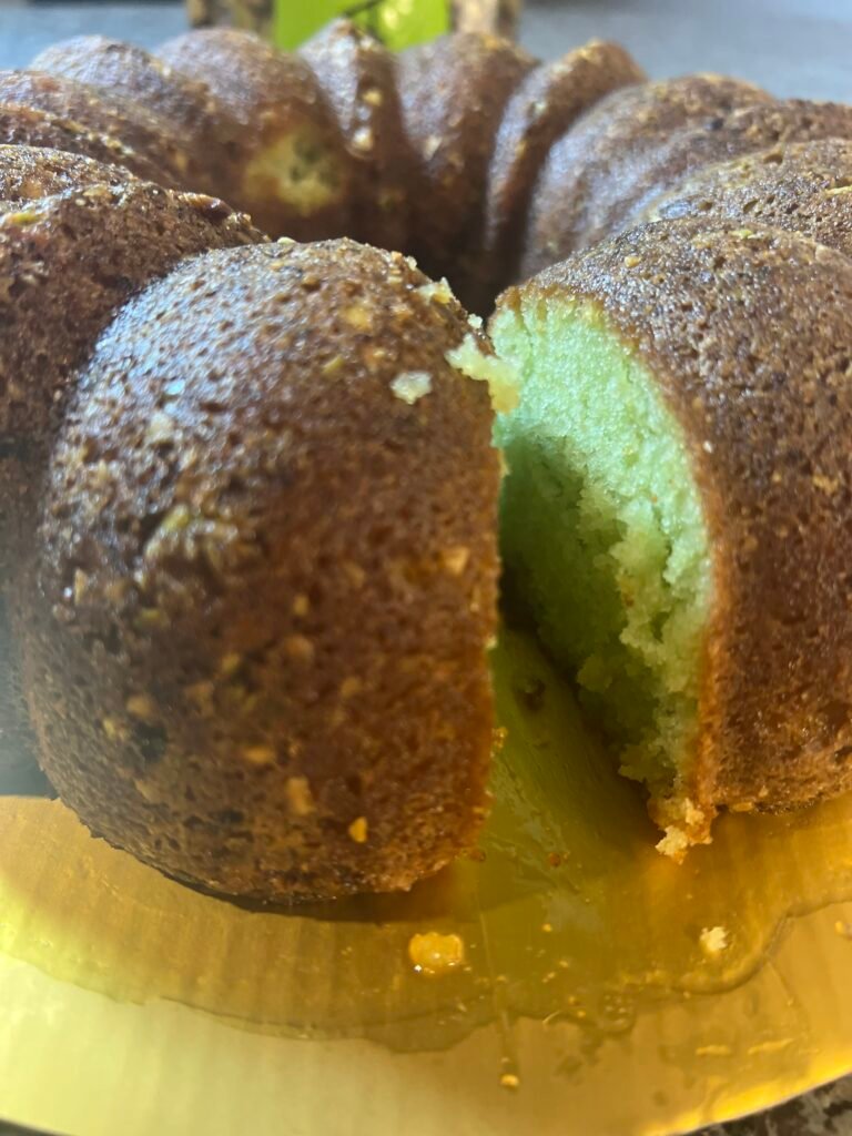 Pistachio cream cake slice on a white plate