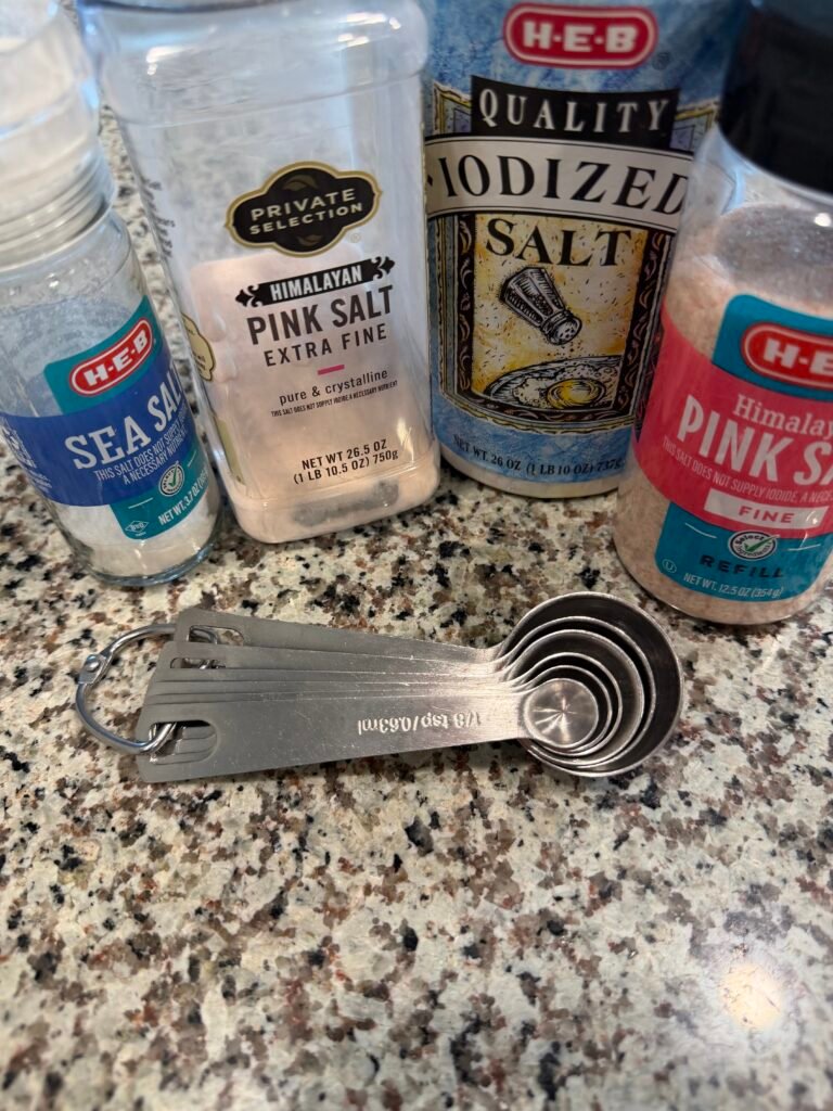 Four different types of salt on a counter.